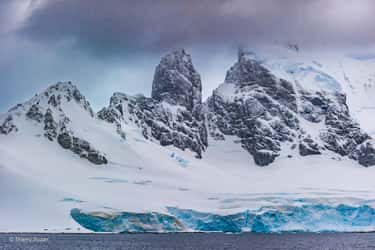 Le Cap Renard, situé en péninsule Antarctique, est un promontoire rocheux marqué par des falaises impressionnantes. Il constitue un point de repère essentiel pour les navigateurs et les explorateurs qui s'aventurent dans ces eaux glacées et inhospitalières. Cap Renard © Thierry Suzan – Tous droits réservés